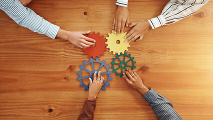 Above, hands and business people with gears for solidarity, solution and support. Collaboration, employees or team building with space, system and pattern problem solving with link puzzle in office