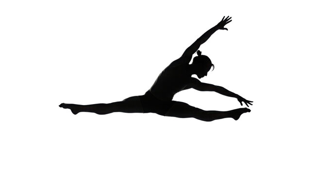 Black silhouette of female dancer performing dynamic horizontal straddle split isolated on Transparent Background