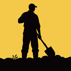 Silhouette of a male farmer at sunset with a shovel, symbolizing hard work and cultivation.