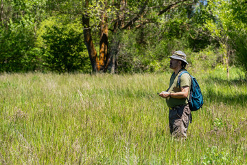 
Mountain hiker checking GPS location while navigating rocky alpine terrain