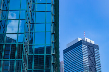 A cityscape of moving cloud reflecting the office building at the business town