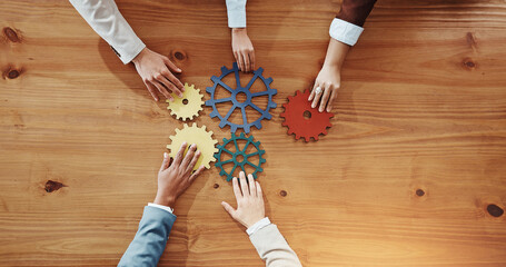 Business people, hands or cogs with gears for team building or problem solving. Top view, group or employees with wheel mesh for cognitive or critical thinking together on wooden table or space