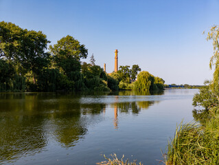 A body of water surrounded by trees and grass