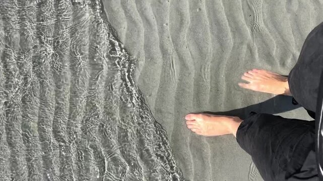 Feet in the Sand as Tide Gently Ebbs and Flows at Tribune Bay, Hornby Island, British Columbia