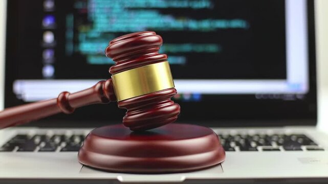 Gavel on laptop, code in background