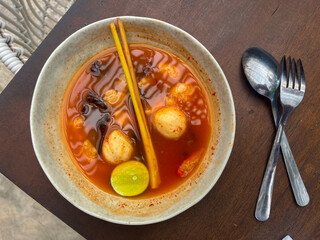 Tom yam soup originating from Thailand. Tom yum is made with shrimp, chili, lime, chicken, fish, or seafood and mushrooms.