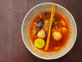 Tom yam soup originating from Thailand. Tom yum is made with shrimp, chili, lime, chicken, fish, or seafood and mushrooms.