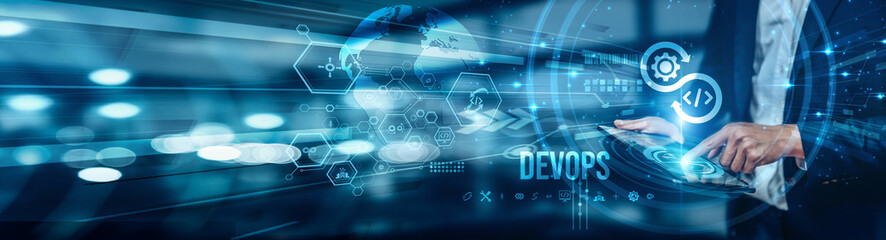 A businessman using a tablet is analyzing DevOps practices and tools to enhance collaboration between development and operations teams, accelerate deployment cycles, improve application reliability.