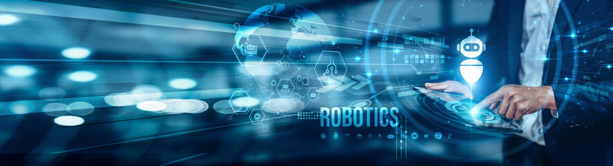 A businessman using a tablet is analyzing robotics by leveraging advanced software tools for robot...