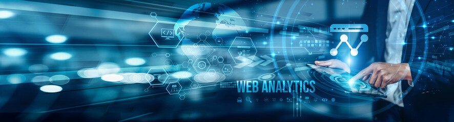 A businessman using a tablet is analyzing web analytics data to track website traffic, optimize...