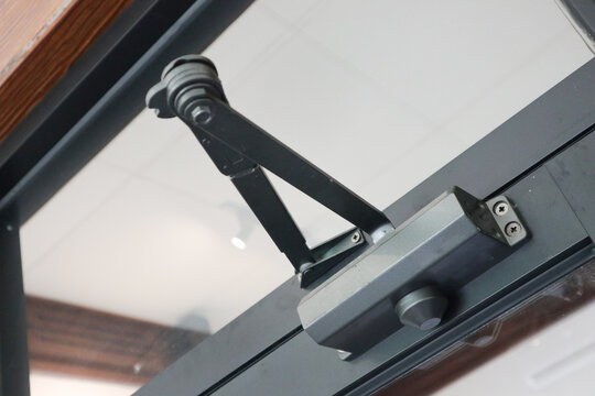 door closer. open closer on a glass door in the interior, a device for controlling the process of damping closing and opening,