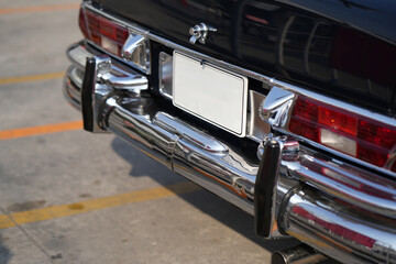 The position and mounting of license plates on classic cars, showing standard rear placement with...
