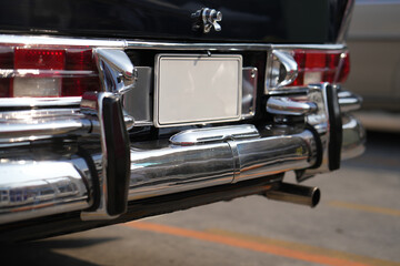 The position and mounting of license plates on classic cars, showing standard rear placement with...