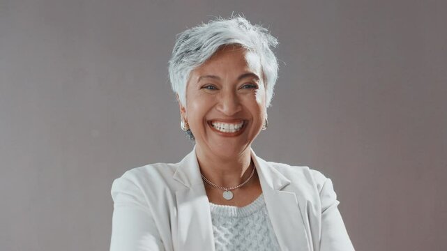 Face, business and woman laugh in studio for comedy screenwriter, script author and career pride. Portrait, mature director and about us for humor, funny joke and positive attitude on gray background