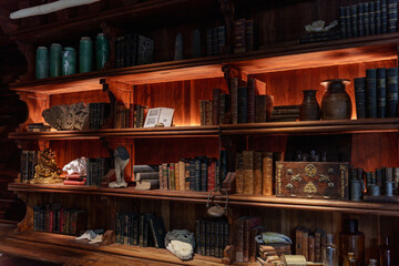 old wooden bookshelf with books and mysterious objects.