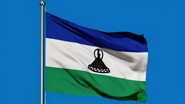 National Flag of Lesotho Waving on a Flagpole Against a Clear Blue Sky