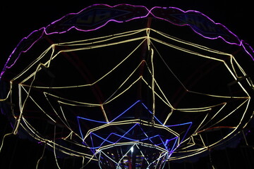 Colorful umbrella-shaped light installation glowing at night. Ideal for festival, celebration,...