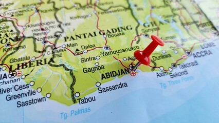 View of Abidjan, is the largest city and the former capital of Ivory Coast, on a geographical map of Africa, marked with red push pin