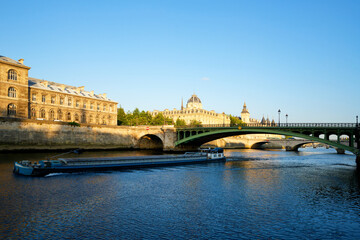Barge on the Seine river and Notre-Dame bridge in the 4th arrondissement of Paris city