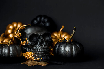 Halloween celebration. Black skull with golden roses and pumpkins. Decor for the Day of the Dead or...