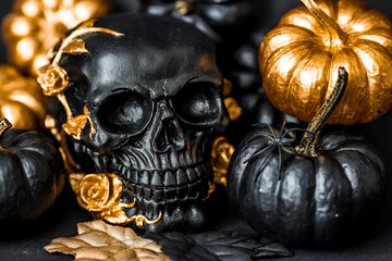 Halloween celebration. Black skull with golden roses and pumpkins. Decor for the Day of the Dead or...