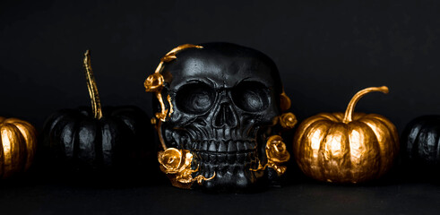 Halloween celebration. Black skull with golden roses and pumpkins. Decor for the Day of the Dead or...