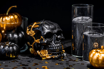 Halloween celebration. Black skull with golden roses, pumpkins, and black candles. Decor for the...