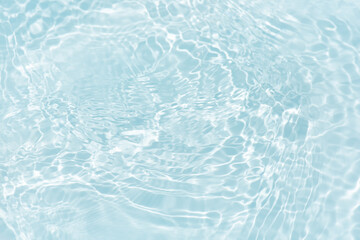 Blue water with ripples on the surface. Defocus blurred transparent blue colored clear calm water...