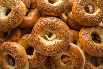 a pile of bagels covered in a golden-brown, grainy topping