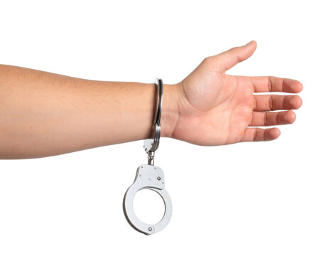 Hand in metal handcuffs with open palm gesture showing arrest detention restraint concept