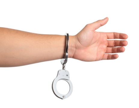 Hand in metal handcuffs with open palm gesture showing arrest detention restraint concept