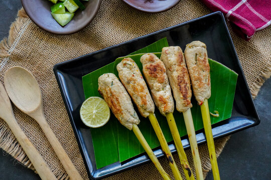 Sate lilit or satay lilit food from Bali, Indonesia. Sate can be made from fish, or chicken, beef, mixed with grated coconut, thick coconut milk wrapped around lemongrass stalks