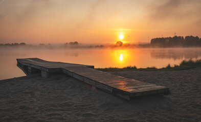 Obraz premium Sunrise over the lake. Sunny June morning.