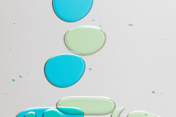 Abstract Close-Up of Colorful Liquid Bubbles on a Clear Surface