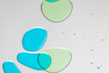 Abstract Close-Up of Colorful Liquid Bubbles on a Clear Surface