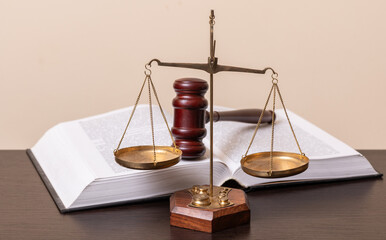 The scales of justice, the judge's gavel and an open book
