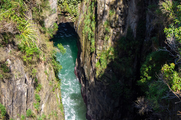 Aerial View of a Lush Green Gorge with Turquoise Water