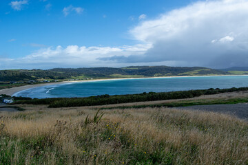Tranquil Beach View with Lush Green Hills