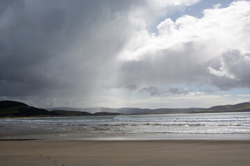 Dramatic Beach Scene with Clouds and Sunlight