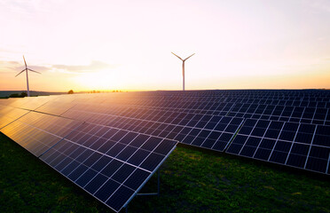 Wind power turbines and solar panels generating green energy electric.Solar panels park and wind...