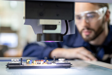 Male and femal engineers checking or maintenance electronic in AI or artificial intelligence Robot, robot arm in the manufacturing automation and robotics manufacture room. Service technical engineer.