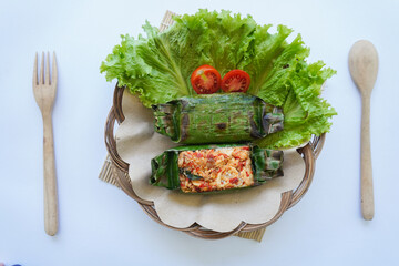 Nasi bakar is an Indonesian food, rice wrapped in banana leaves and then grilled. Rice filled with...