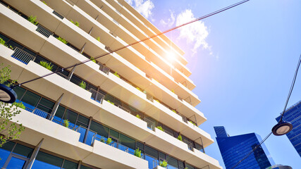 Modern office building with glass facade. Transparent glass wall of office building. Reflection of...