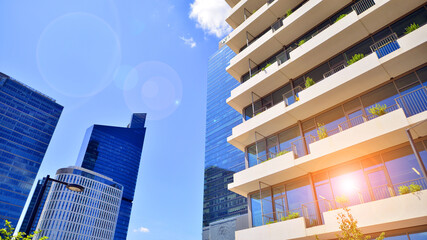 Modern office building with glass facade. Transparent glass wall of office building. Reflection of...