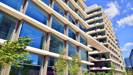 Office with green environment. Corporate building reduce CO2. Sustainable glass office building...