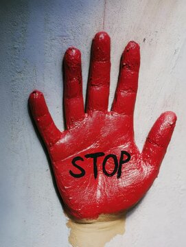 Bold red handprint with the word stop sends a powerful message about safety in urban settings