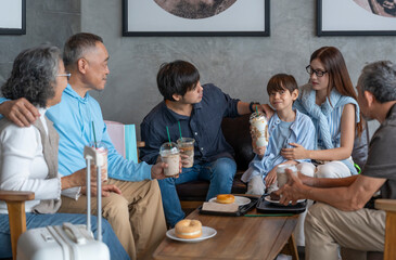 happy three generation family enjoy talking,drinking,eating together in cafe during shopping in the mall,a cozy moment,family outing on summer vacations,travel