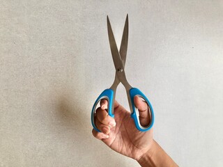 hand holding scissors