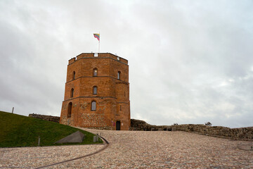 Red brick Gediminas tower in Vilnius on top of a hill with cloudy sky, Lithuania