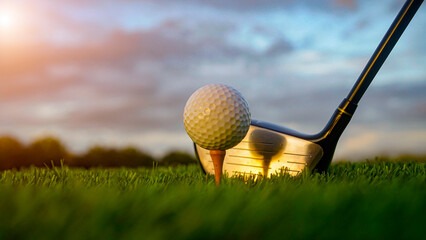 Golf clubs and balls on a green lawn in a beautiful golf course with morning sunshine.